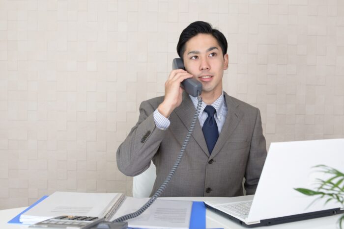 管理会社の担当者が電話対応している様子